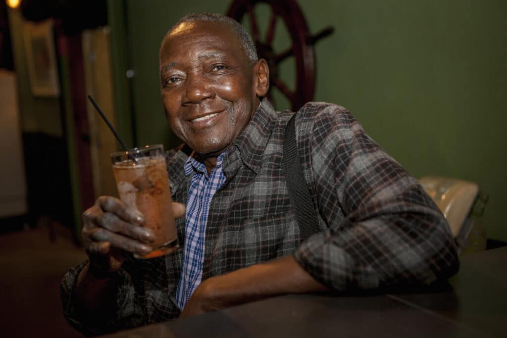 Portrait of senior man drinking cocktail in bar, Rio De Janeiro, Brazil