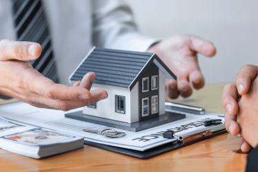 Man presenting a model of a house